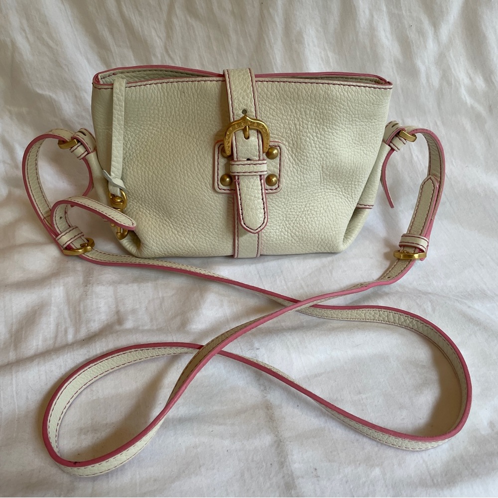 Dooney & Bourke crossbody bag. White leather with pink trim.